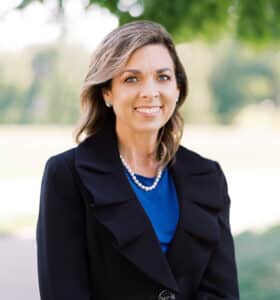 woman wearing blue shirt and black jacket