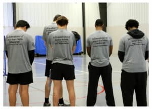 Students in prayer at the 2026 Fallen Officer Project’s pickleball tournament, held April 19 at C-SC.