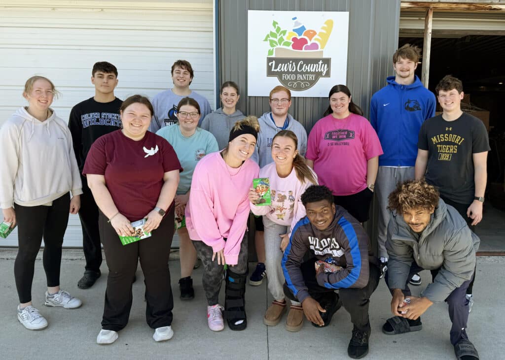 College students standing in front of a rural food pantry.