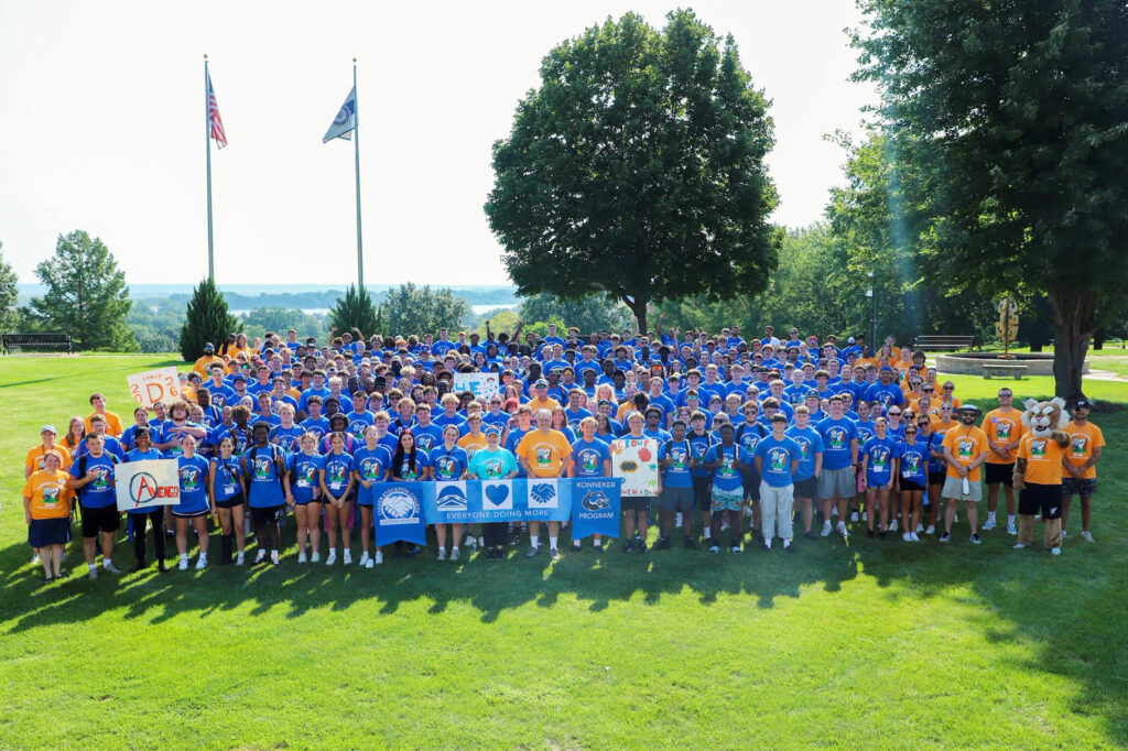 college students posted on a campus quad for a group photo
